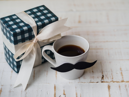 Happy father's day concept. gift box, a cup of coffee with mustache on white background.の写真素材