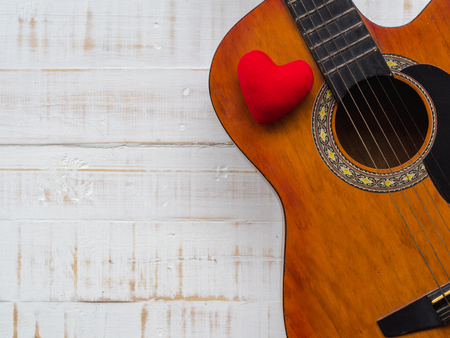 The guitar and red heart on white wooden texture background. Love, Music day concept.の写真素材