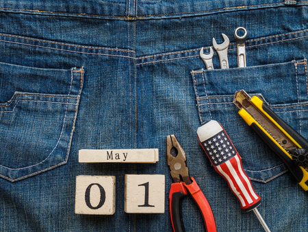 wooden block calendar 1 May and Joinery tools on a jean texture background. Labor day concept.の写真素材