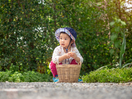Happy little girl hold the basket in the farm. Farming & Children Concept.の写真素材