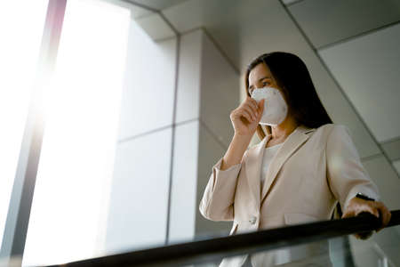 Asian woman wearing N95 face mask to protect pollution PM2.5 and virus. COVID-19 Coronavirus and Air pollution pm2.5 Healthcare and medical concept.の写真素材