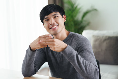 Young Asian deaf disabled man using Sign Language to communicate with other people.の写真素材