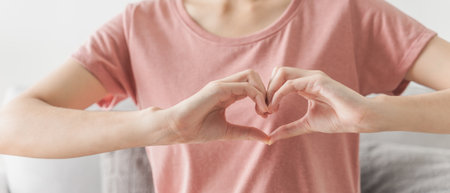 Woman making hands in heart shape, Love, heart health insurance, social responsibility, donation, happy charity volunteer, world heart day, appreciate, world mental health, cancer dayの写真素材