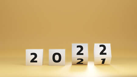 start to year 2022. white cube block flipping to change 2021 year to 2022 year on yellow background...