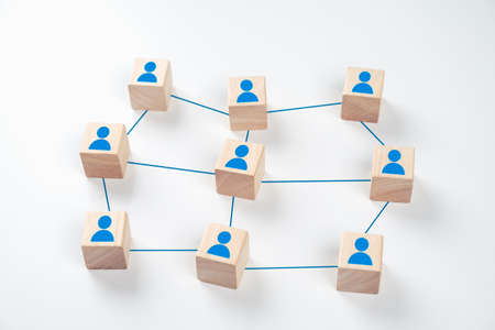 Wooden cube blocks are connected together with blue lines on white background. Teamwork, Leadership, Business, human resource management Conceptの写真素材