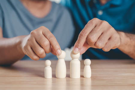 Wooden peg dolls family, with man and woman couple. planning, saving family,  health care and insurance, family mental health, international day of familiesの写真素材