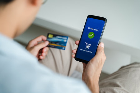 Man holding credit card and using smartphone for online shopping, internet banking, e-commerce,...