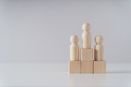 wooden figures peg doll standing on the podium of wooden cube blocks with copy space. ranking and strategy concept.の写真素材