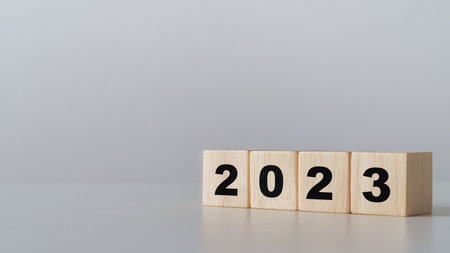 start to year 2022. wooden cube block with 2023 year text. happy new years concept.の写真素材