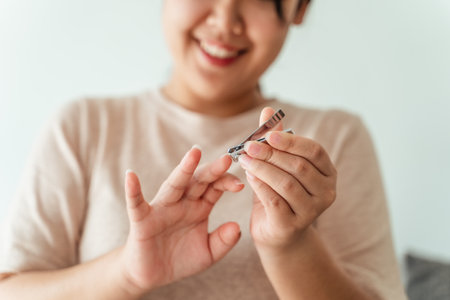 Woman cutting fingernails using nail clipper, Healthcare, Beauty Concept.の写真素材