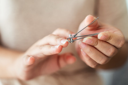 Woman cutting fingernails using nail clipper, Healthcare, Beauty Concept.