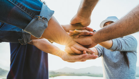 People putting their hands together. Friends with a stack of hands showing unity and teamwork....