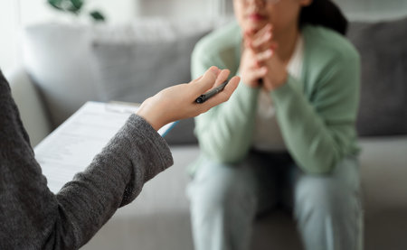 Psychologist doctor examine and listen and talking to patient with depression, anxiety, therapy session, mental health conceptの写真素材