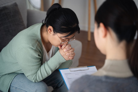Psychologist doctor examine and listen and talking to patient with depression, anxiety, therapy session, mental health conceptの写真素材