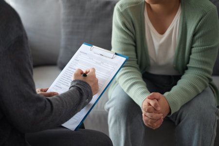 Psychologist doctor examine and listen and talking to patient with depression, anxiety, therapy session, mental health conceptの写真素材