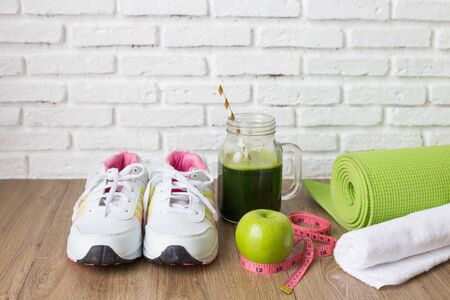 Healthy concept,sneaker,apple,with drinking vegetable juice on wooden backgroundの写真素材