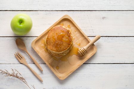Delicious pancakes with apple on white  wooden table top viewの写真素材
