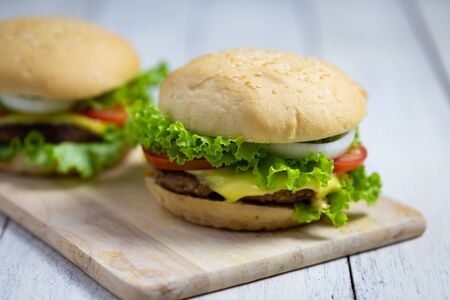 Homemade hamburgers on wooden boardの写真素材