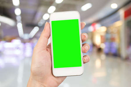 young woman hand using smart phone on Supermarket blur backgroundの写真素材