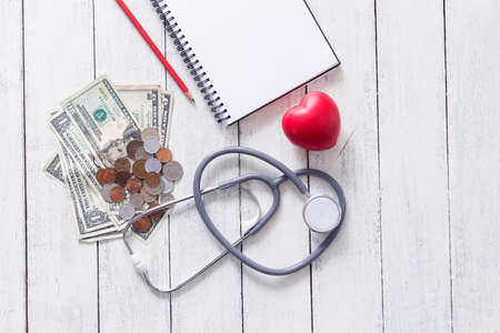 Healthy concept,red heart with stethoscope and notebook on white wood backgroundの写真素材