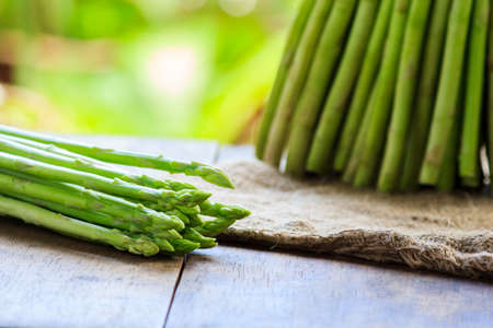 fresh asparagus on wooden tableの写真素材