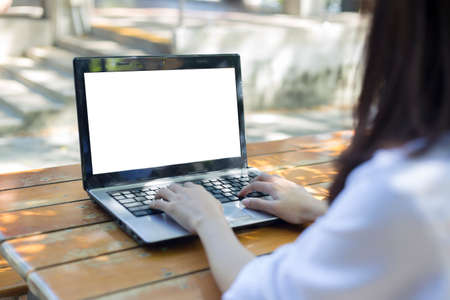 young woman working laptop computer on wood desk ,Empty notebookの写真素材