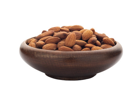 Almonds on a wooden bowl Isolated on white backgroundの写真素材