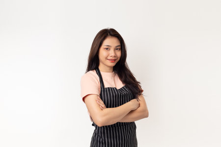 Portrait of confident asian woman barista standing on white background. female confidently starting a new businessの写真素材