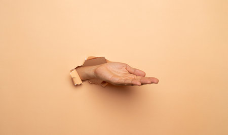 Close-up of empty man hand on brown backgroundの写真素材