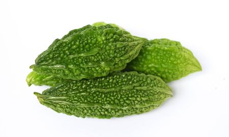 Closeup view of bitter gourd over vegetable garden concept on a white backgroundの写真素材
