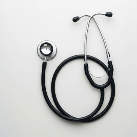A classic black medical stethoscope rests on a bright white background, ready for examination.の素材