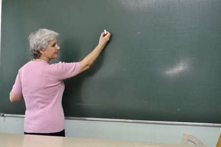 School teacher lady at the lesson in the classroomの写真素材