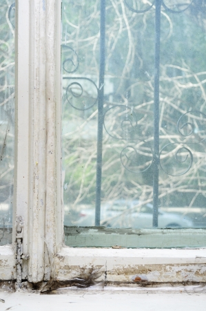 Background of neglected window with layers of old paintの写真素材