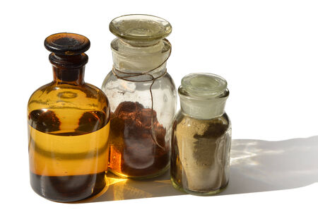 A set of chemical bottles with different content isolated on whiteの写真素材