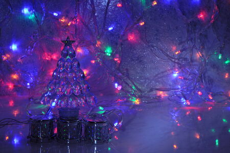 Christmas background with new year tree decoration and shining garland lights.の写真素材