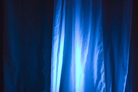 Blue Spot Lights Against Stage Curtain Backgroundの写真素材