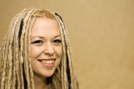 Smiling Woman with Face Piercings and Dread Lock Hair