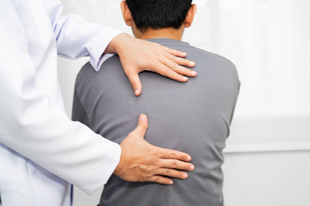 Physical therapy, Asian therapist doctor treat perform pain young man in hospital.