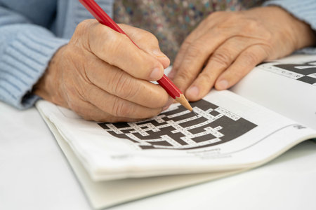 Bangkok, Thailand - January 19, 2025 elderly woman playing puzzle game.の写真素材