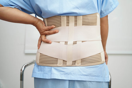 Asian woman wearing lumbar support pain back and use walker in hospital.の写真素材