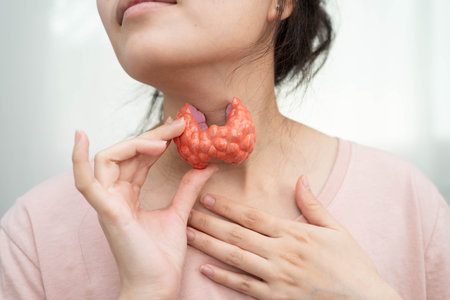 Hyperthyroidism, Overactive Thyroid, Thyroid Lymphoma, Asian woman with thyroid gland human anatomy model.の写真素材