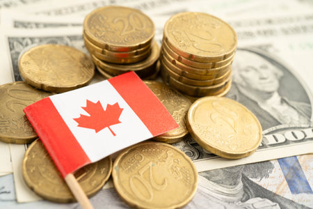 Canada flag on coin and banknote money, finance trading investment business currency.の写真素材