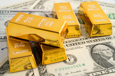 Gold bars with US dollar banknote money, finance trading investment business currency.