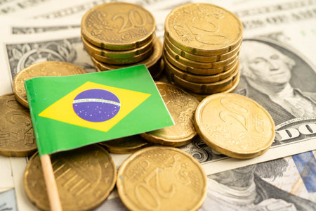Brazil flag on coin and banknote money, finance trading investment business currency.の写真素材
