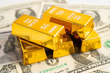 Gold bars with US dollar banknote money, finance trading investment business currency.の写真素材