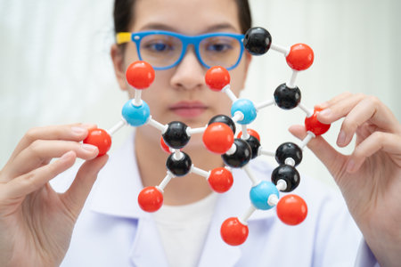 Scientist holding molecular model for chemical technology.