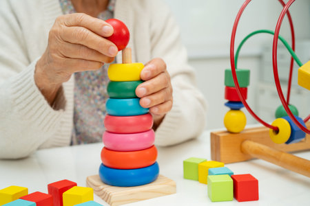 Asian elderly woman playing enhancing skill board game.の写真素材