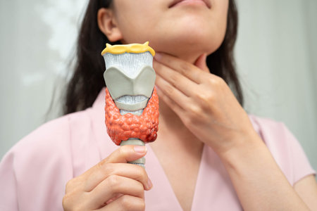 Hyperthyroidism, Overactive Thyroid, Thyroid Lymphoma, Asian woman with thyroid gland human anatomy model.の写真素材