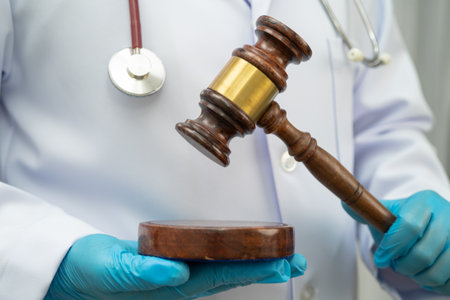 Asian doctor holding court hammer for crime law justice, forensic medicine.の写真素材