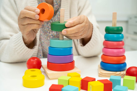 Asian elderly woman playing skill board game.の写真素材